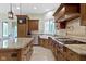 Chef's kitchen featuring a large island, stainless steel appliances, and stone countertops at 10585 Golden Bear Way, Noblesville, IN 46060
