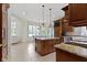 Open kitchen featuring custom cabinets, granite countertops, a center island, and breakfast area at 10585 Golden Bear Way, Noblesville, IN 46060