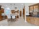 Bright kitchen boasting a center island with bar seating, custom cabinets, and stone countertops at 10585 Golden Bear Way, Noblesville, IN 46060