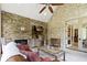 Indoor outdoor living room with beautiful stone fireplace and a comfortable seating area at 10585 Golden Bear Way, Noblesville, IN 46060