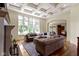 Inviting living room featuring a decorative ceiling, large windows, and comfortable couches at 10585 Golden Bear Way, Noblesville, IN 46060