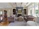 Charming living room showcasing a fireplace, custom built-ins, and coffered ceilings at 10585 Golden Bear Way, Noblesville, IN 46060