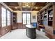 Spacious office features a coffered ceiling, custom built-ins, and large windows providing lots of natural light at 10585 Golden Bear Way, Noblesville, IN 46060