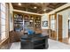Beautiful office featuring custom cabinets, coffered ceilings, and a black work desk at 10585 Golden Bear Way, Noblesville, IN 46060