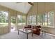 Relaxing sunroom features vaulted ceilings, lots of windows, and views of the well maintained backyard at 10585 Golden Bear Way, Noblesville, IN 46060