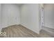 A view of the light-filled entry way with light wood flooring and a white entry door at 1073 E Valley Oak Ct, Mooresville, IN 46158