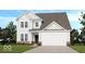 Charming two-story home with a brick foundation, white siding, a two-car garage and landscaped yard at 1073 E Valley Oak Ct, Mooresville, IN 46158