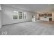 Open-concept living room seamlessly connects to the kitchen, featuring plenty of windows and natural light at 1073 E Valley Oak Ct, Mooresville, IN 46158