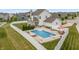 Aerial view of the backyard with a swimming pool, patio area, and privacy fence at 10795 Creekbed Cir, Fishers, IN 46038