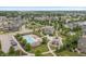 Aerial view of community pool, playground and clubhouse surrounded by well-maintained homes and green spaces at 10795 Creekbed Cir, Fishers, IN 46038