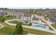 Aerial view of backyard with inground pool, covered patio, fenced yard and beautifully landscaped backyard at 10795 Creekbed Cir, Fishers, IN 46038