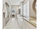 Bright bathroom featuring a modern tub, double vanities, walk-in shower, and neutral color palette at 10795 Creekbed Cir, Fishers, IN 46038