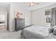 Comfortable bedroom with dresser, soft carpet, ceiling fan, a bed, and a well-lit adjoining bath at 10795 Creekbed Cir, Fishers, IN 46038