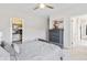 Comfortable bedroom with dresser, soft carpet, ceiling fan, and walk-in closet at 10795 Creekbed Cir, Fishers, IN 46038