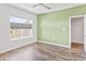Cozy bedroom featuring hardwood floors, large window with blinds and natural light, plus an accent wall at 10795 Creekbed Cir, Fishers, IN 46038