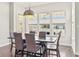 Cozy dining room offers modern chandelier and ample natural light at 10795 Creekbed Cir, Fishers, IN 46038