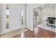Bright entryway with white door, hardwood floors, and view into the office at 10795 Creekbed Cir, Fishers, IN 46038