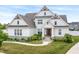 Charming two story home featuring a concrete walkway surrounded by lush landscaping at 10795 Creekbed Cir, Fishers, IN 46038