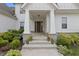 Inviting front porch with stone accents and colorful potted plants at 10795 Creekbed Cir, Fishers, IN 46038