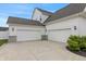 Spacious three-car garage with ample parking space and modern exterior lighting, offering convenience and curb appeal at 10795 Creekbed Cir, Fishers, IN 46038