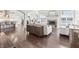 Bright open-concept living room featuring hardwood floors and a stone fireplace at 10795 Creekbed Cir, Fishers, IN 46038