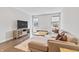 Relaxing living room featuring modern furniture, neutral colors, hardwood floors and natural light streaming through windows at 10795 Creekbed Cir, Fishers, IN 46038
