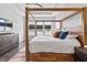 Bright primary bedroom with a wood frame bed, a ceiling fan and lots of natural light at 10795 Creekbed Cir, Fishers, IN 46038
