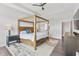 Tranquil bedroom features a rustic wood frame bed, a ceiling fan and lots of natural light at 10795 Creekbed Cir, Fishers, IN 46038