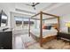 Comfortable bedroom boasts a wood frame bed, a ceiling fan and lots of natural light at 10795 Creekbed Cir, Fishers, IN 46038