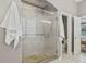 Modern bathroom showcasing a glass-enclosed shower, stone flooring and tilework at 10795 Creekbed Cir, Fishers, IN 46038
