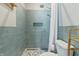 Shower with blue tile, built-in niche, pebble floor, and white shower curtain at 10795 Creekbed Cir, Fishers, IN 46038