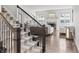 Staircase with carpeted treads and wrought iron railings leading to the upper level at 10795 Creekbed Cir, Fishers, IN 46038
