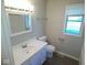 Bathroom featuring a vanity, updated sink, toilet, and a window providing natural light at 1155 E Perry St, Indianapolis, IN 46227