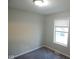A bright bedroom features neutral paint, carpet flooring, and a window allowing natural light at 1155 E Perry St, Indianapolis, IN 46227