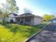 Charming home exterior with a covered front porch, green lawn, and mature trees at 1155 E Perry St, Indianapolis, IN 46227