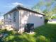 Home exterior showcasing neutral siding, well-maintained landscaping, and an efficient AC unit at 1155 E Perry St, Indianapolis, IN 46227