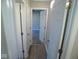 Hallway with updated flooring that connects the bedrooms and bathroom at 1155 E Perry St, Indianapolis, IN 46227