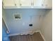 Well-maintained utility area with washer/dryer hookups and overhead storage cabinets at 1155 E Perry St, Indianapolis, IN 46227