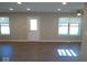Bright living room featuring modern flooring, recessed lighting, and natural light from windows at 1155 E Perry St, Indianapolis, IN 46227
