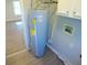 Utility area with a modern water heater and connections for laundry appliances at 1155 E Perry St, Indianapolis, IN 46227