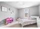 Charming bedroom with soft carpet features a white bed frame and colorful storage unit at 1158 Thistlewood Way, Plainfield, IN 46168