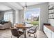 Bright dining area featuring a round table, modern chairs, and a sliding glass door at 1158 Thistlewood Way, Plainfield, IN 46168