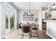 Bright dining area features wood floors, shelving, pendant lighting and sliding glass doors to the outdoors at 1158 Thistlewood Way, Plainfield, IN 46168