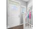 Bright entryway featuring a white door with half-round window and elegant staircase at 1158 Thistlewood Way, Plainfield, IN 46168