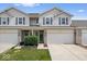 Charming townhouse featuring a well-maintained lawn, 2-car garage, and inviting front entrance at 1158 Thistlewood Way, Plainfield, IN 46168