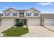 Charming two-story townhouse featuring a two-car garage and well-maintained front yard at 1158 Thistlewood Way, Plainfield, IN 46168