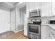 Modern kitchen featuring stainless steel appliances, quartz counters, and white cabinets at 1158 Thistlewood Way, Plainfield, IN 46168