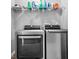 Well-equipped laundry room featuring a modern washer and dryer with storage shelf above at 1158 Thistlewood Way, Plainfield, IN 46168