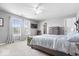 Spacious main bedroom boasts a ceiling fan, plush carpet, and bright windows with charming curtains at 1158 Thistlewood Way, Plainfield, IN 46168