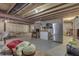 Unfinished basement features exposed ductwork and a ping pong table, refrigerator, and shelving at 1202 Vestman Ct, Greenwood, IN 46143